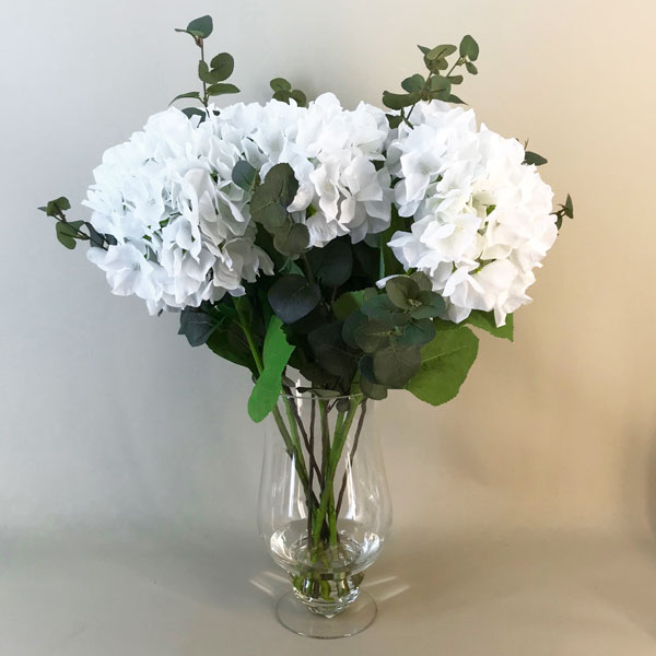 Fake white shop flowers in vase